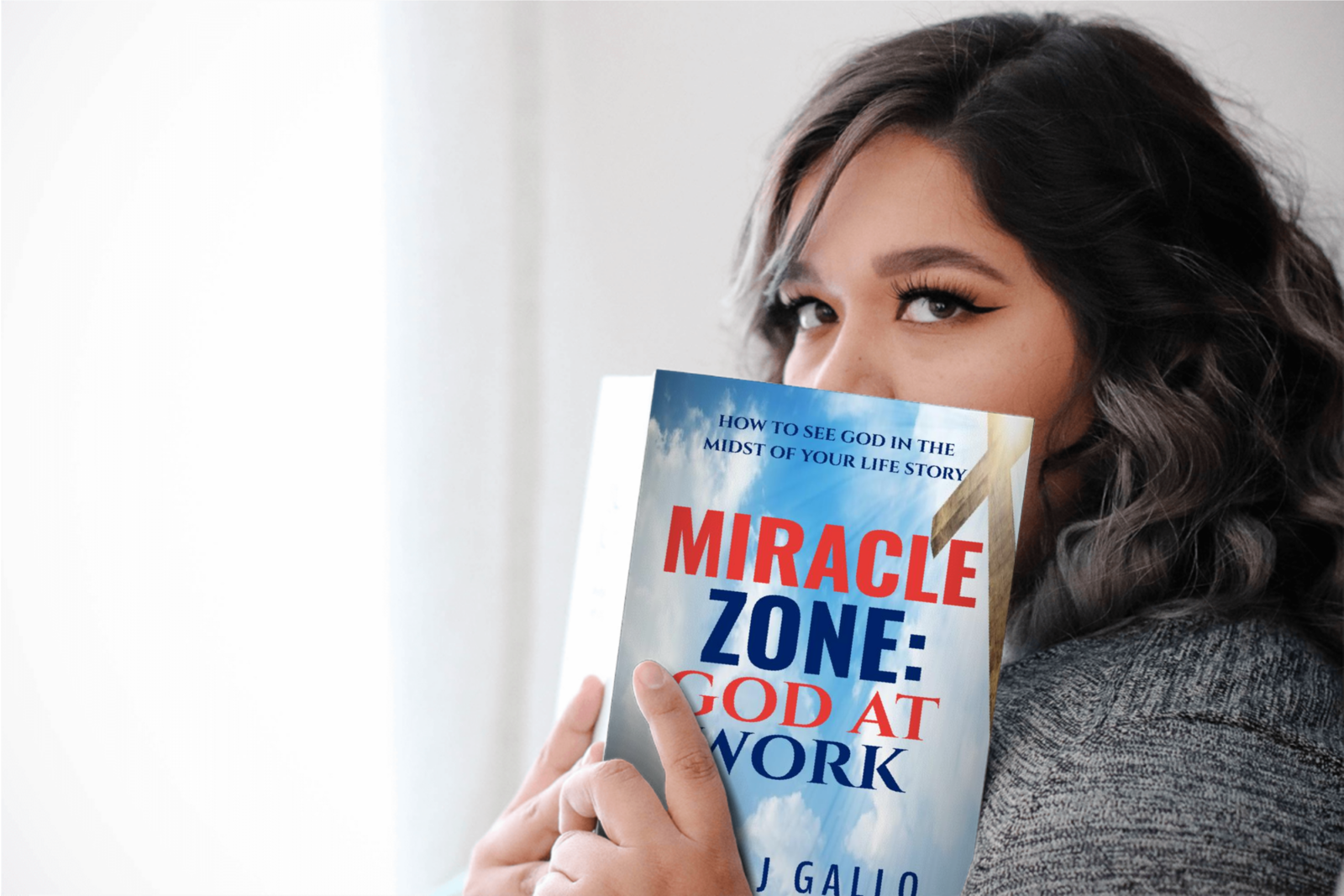 girl holding Miracle Zone book as looking over it